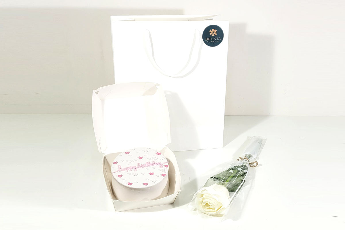 white single rose with cake