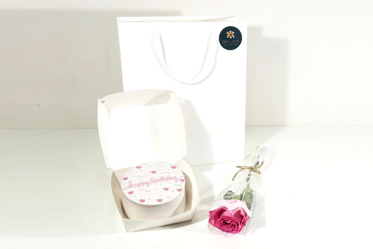 pink single rose with cake