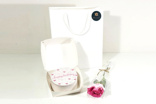 pink single rose with cake