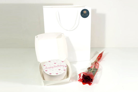 red single rose with cake