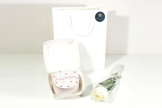 white single rose with cake